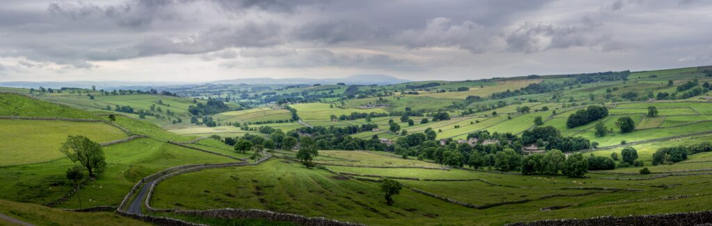 Open British countryside with green fields and natural habitat under a wide sky